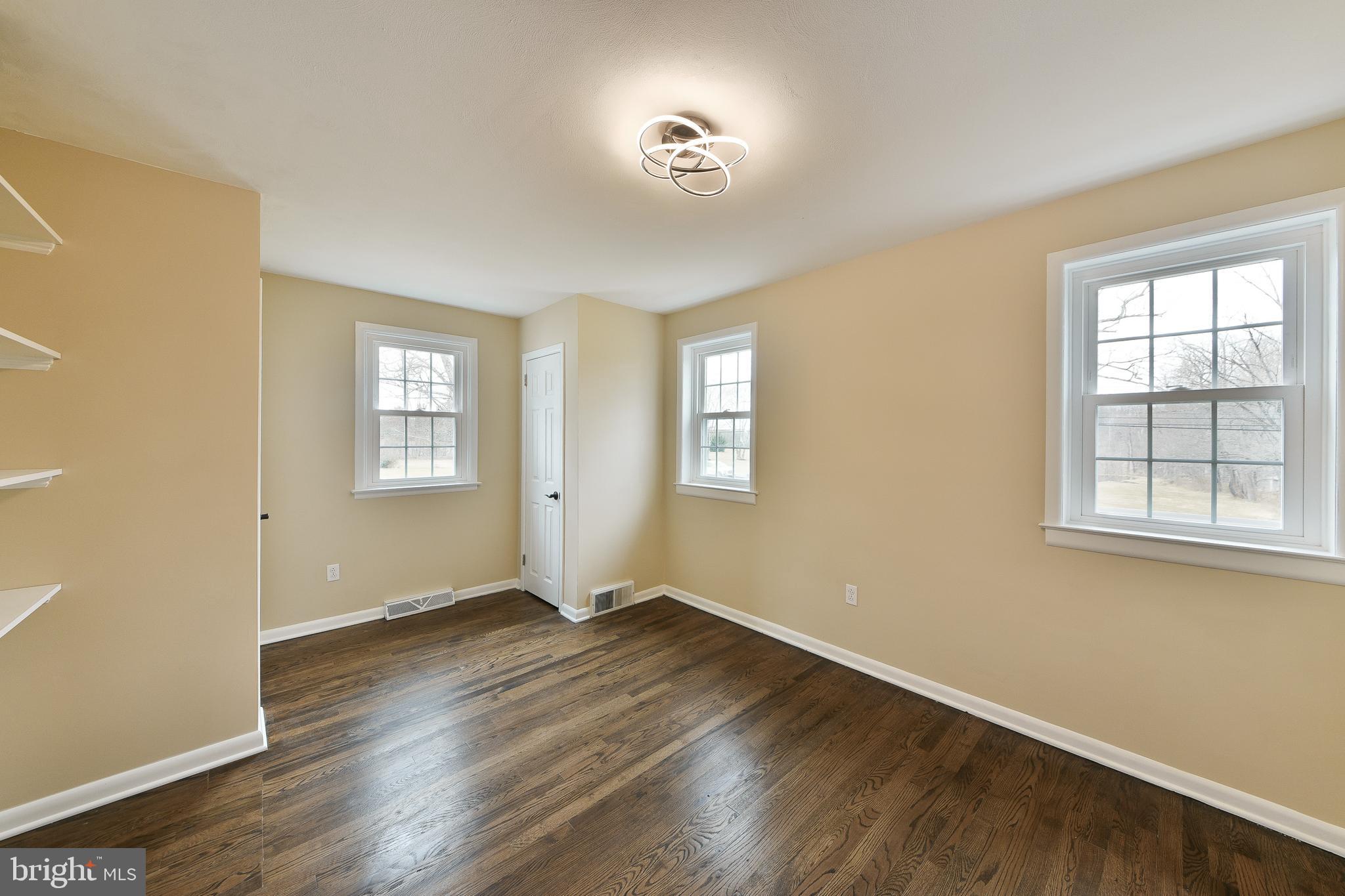 6166 Mechanicsville Road Doylestown, PA 18902 - Photo 11 of 29 a view of an empty room with wooden floor and a window