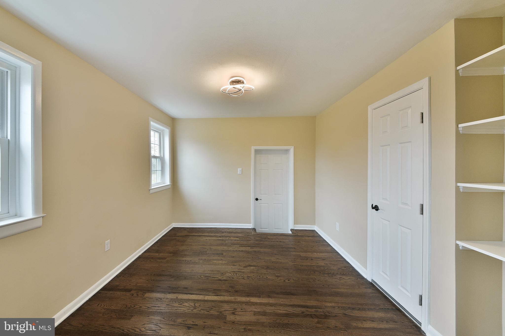 6166 Mechanicsville Road Doylestown, PA 18902 - Photo 12 of 29 a view of an empty room with wooden floor and a window