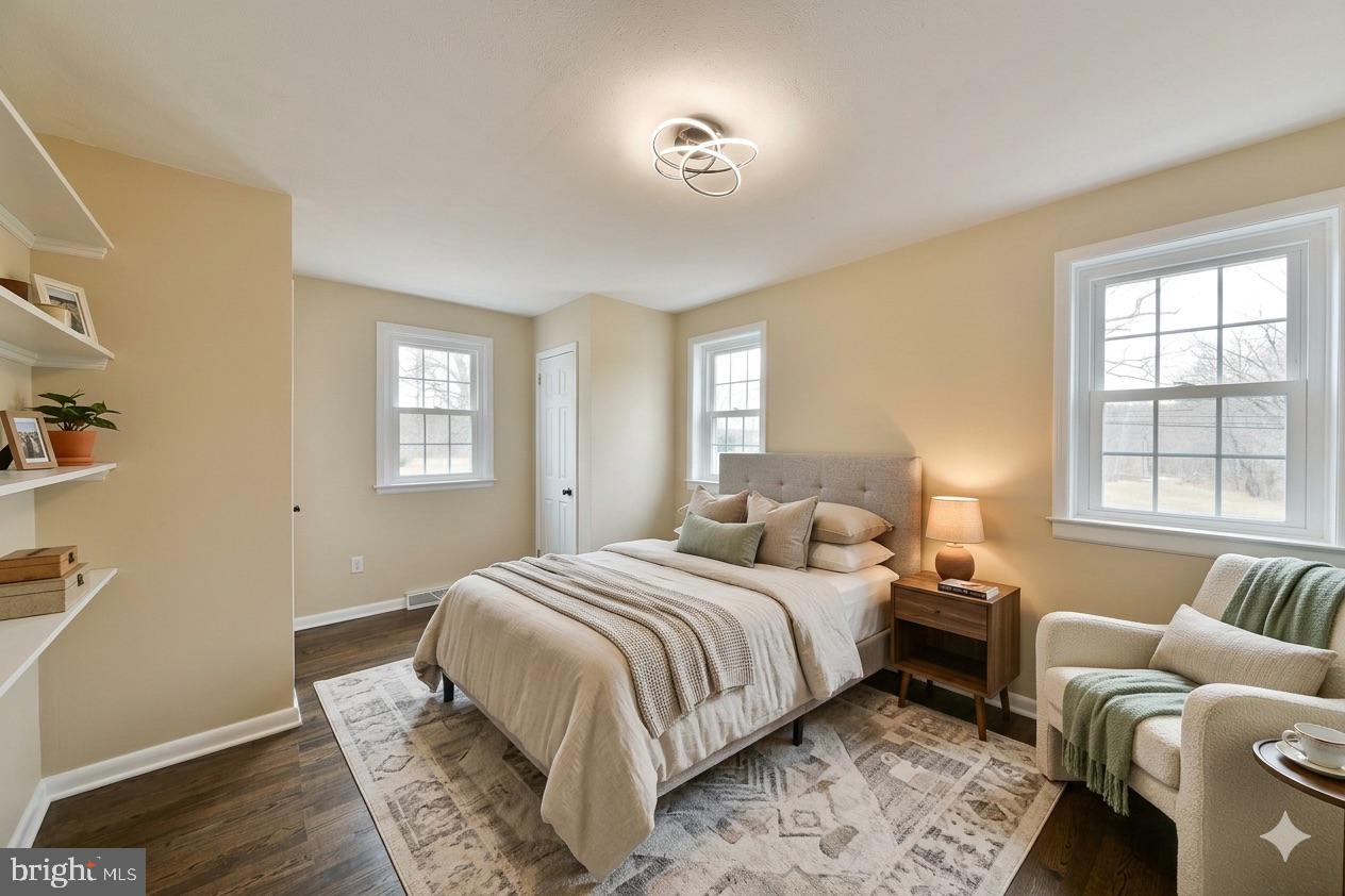 6166 Mechanicsville Road Doylestown, PA 18902 - Photo 10 of 29 a bedroom with a bed and wooden floor