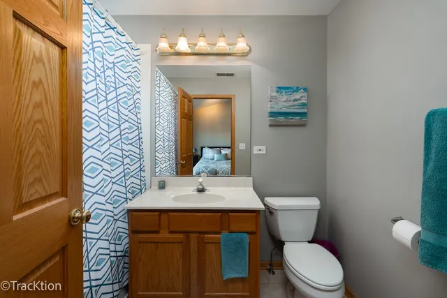 a bathroom with a toilet a sink and mirror