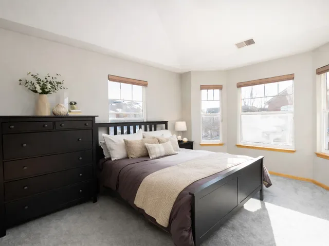 a bedroom with a bed and window