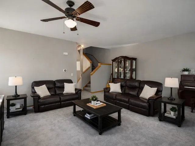 a living room with furniture and a lamp