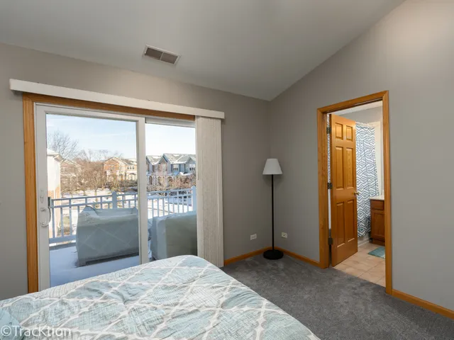 a bedroom with a bed and a large window