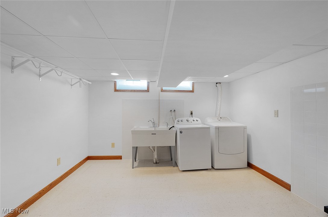 5611 Ralston Drive Parma, OH 44129 - Photo 23 of 39 Laundry area with washer and dryer and baseboards