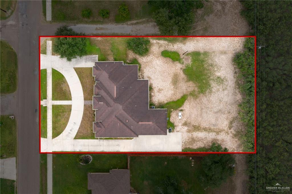 401 Ric Mar Street Edinburg, TX 78541 - Photo 17 of 18 Aerial property overview featuring a multi-gabled roofline, concrete driveway, and a substantial undeveloped lot
