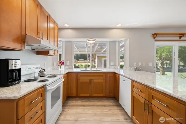 a kitchen with a sink stove and cabinets