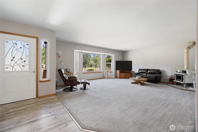 a view of a livingroom with furniture and a window