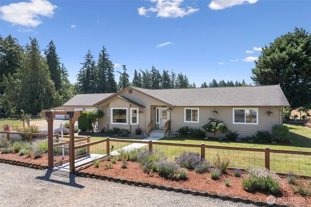 a front view of house with yard and green space
