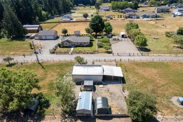 a view of a yard with a house in the background
