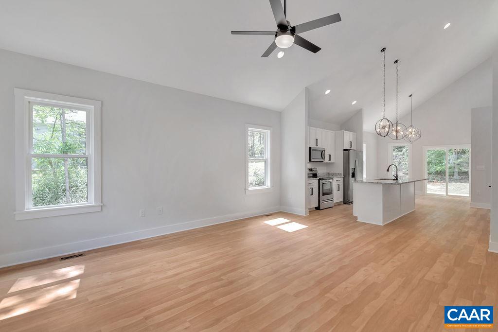 24 Begum Road Palmyra, VA 22963 - Photo 11 of 47 a view of a kitchen with a kitchen island wooden floor appliances and a window