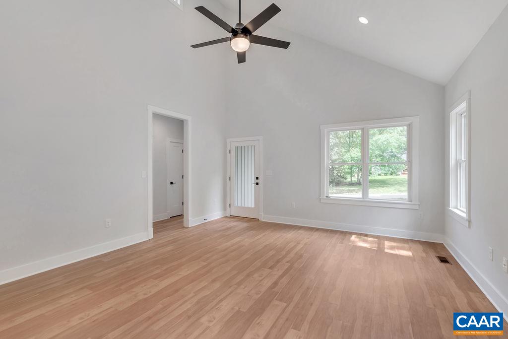 24 Begum Road Palmyra, VA 22963 - Photo 13 of 47 an empty room with wooden floor fan and windows