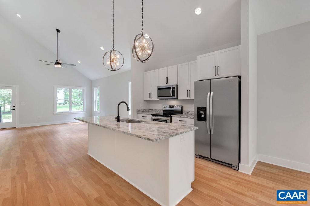 24 Begum Road Palmyra, VA 22963 - Photo 16 of 47 a kitchen with stainless steel appliances granite countertop a refrigerator a stove top oven a sink dishwasher and white cabinets with wooden floor