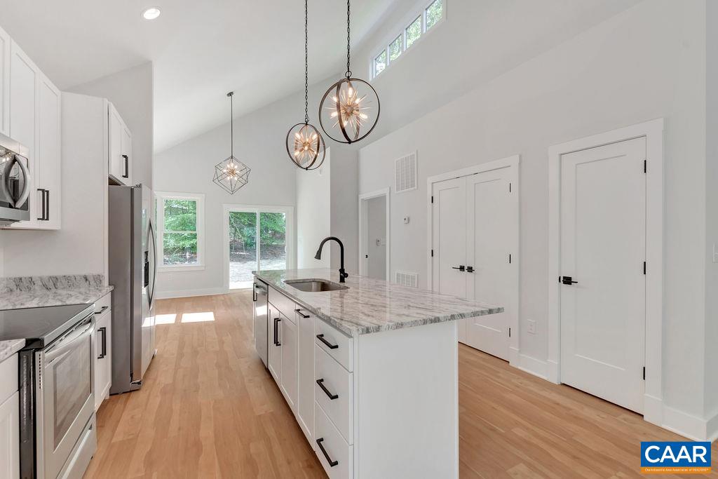 24 Begum Road Palmyra, VA 22963 - Photo 17 of 47 a very nice looking kitchen with granite countertop a stove oven a sink dishwasher and white cabinets with wooden floor