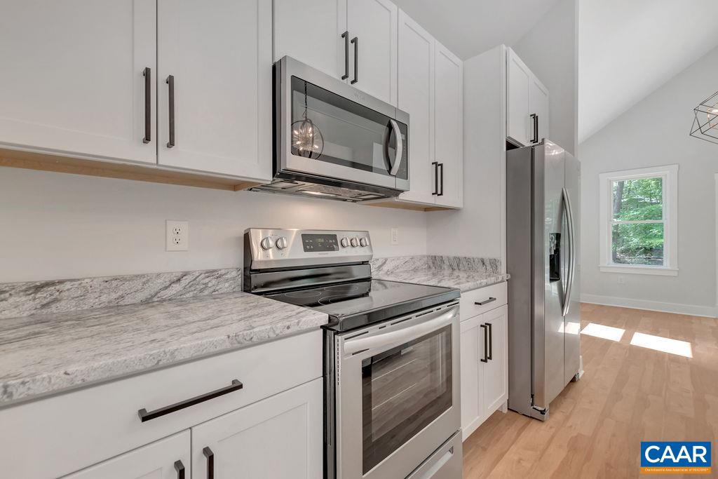 24 Begum Road Palmyra, VA 22963 - Photo 20 of 47 a kitchen with stainless steel appliances granite countertop a stove a microwave and a refrigerator
