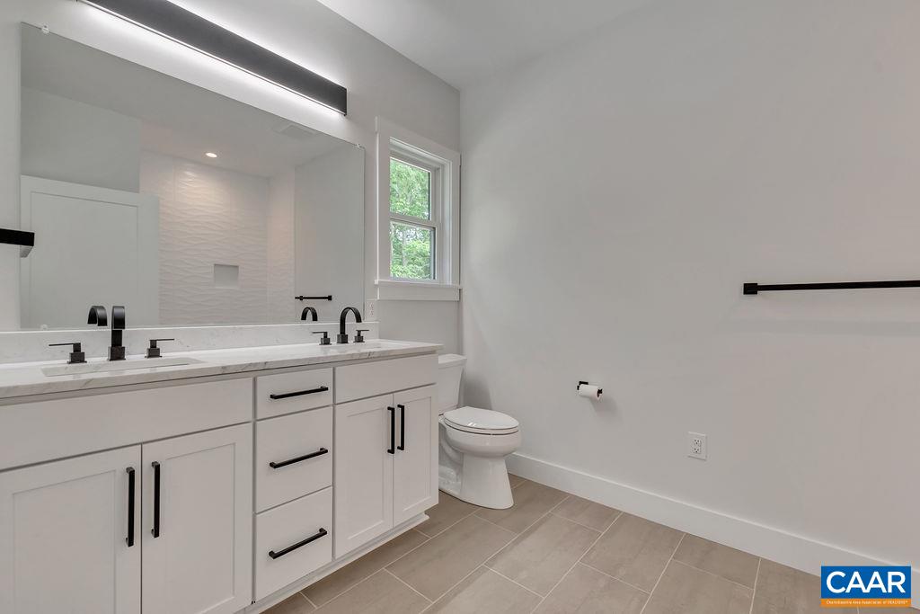 24 Begum Road Palmyra, VA 22963 - Photo 31 of 47 a bathroom with a toilet sink and mirror