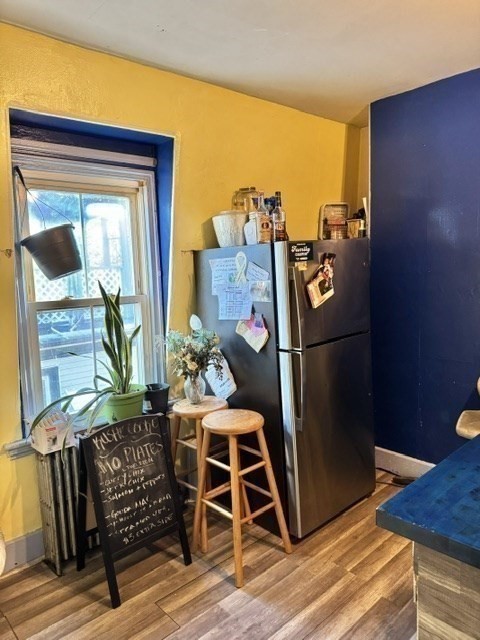 495 Warren Street Boston, MA 02121 - Photo 17 of 25 a bed sitting in a bedroom next to a window