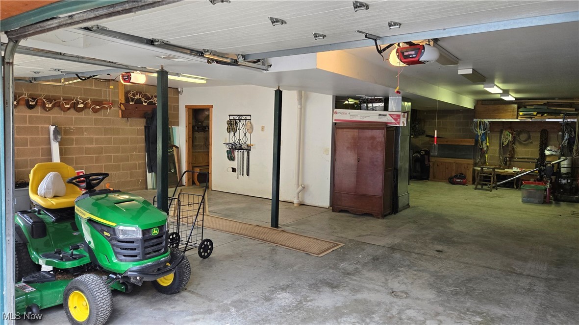 587 North Fork Road Wheeling, WV 26003 - Photo 26 of 35 Garage with a garage door opener and concrete block wall
