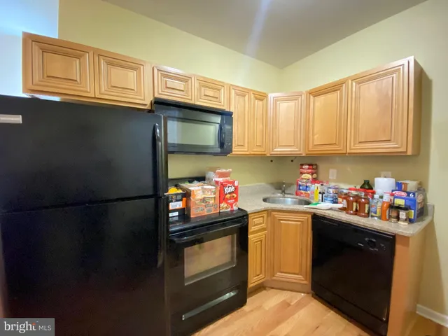 a kitchen with stainless steel appliances a refrigerator stove microwave and sink