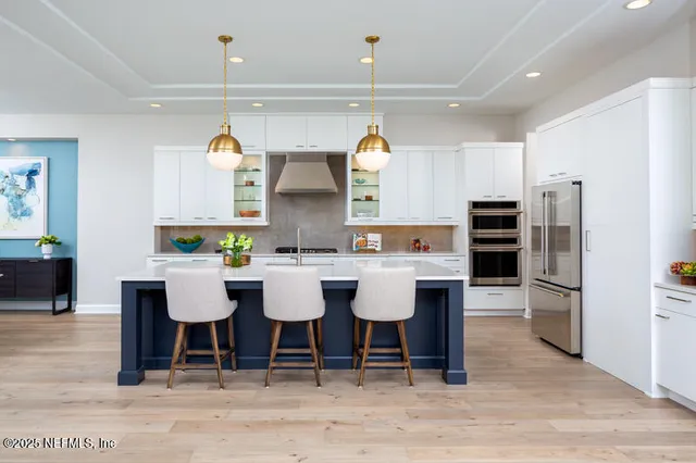 a large kitchen with a table and chairs