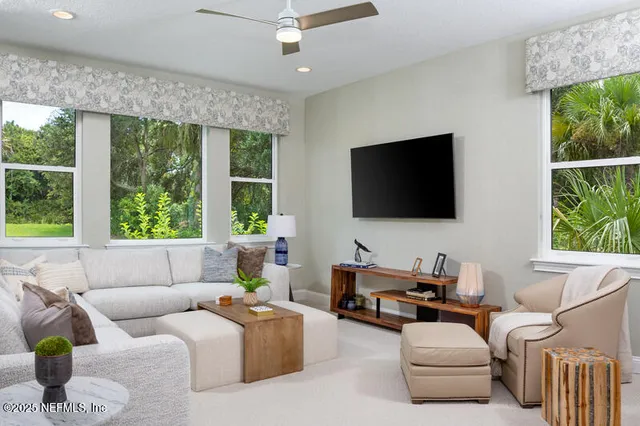 a living room with furniture and a flat screen tv
