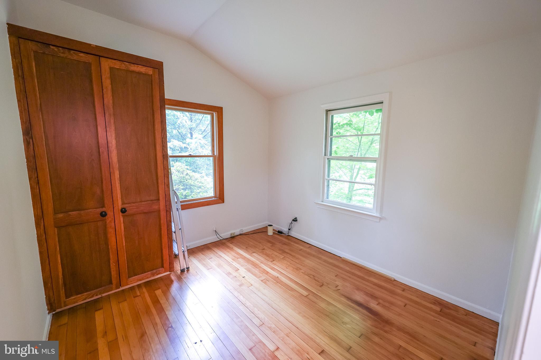 98 Swindler Hollow Road Sperryville, VA 22740 - Photo 13 of 25 an empty room with wooden floor and windows