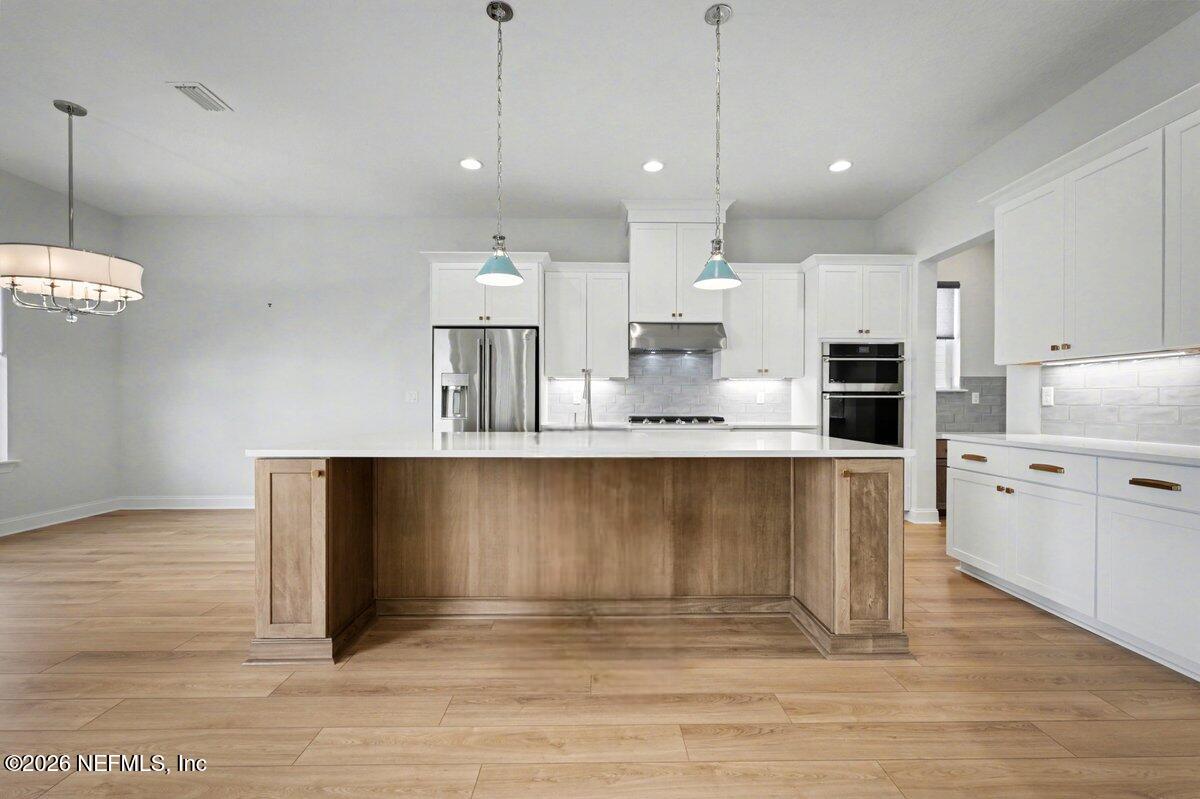 113 Grand Rivage Drive St. Augustine, FL 32092 - Photo 12 of 22 a kitchen with kitchen island a counter top space appliances and cabinets