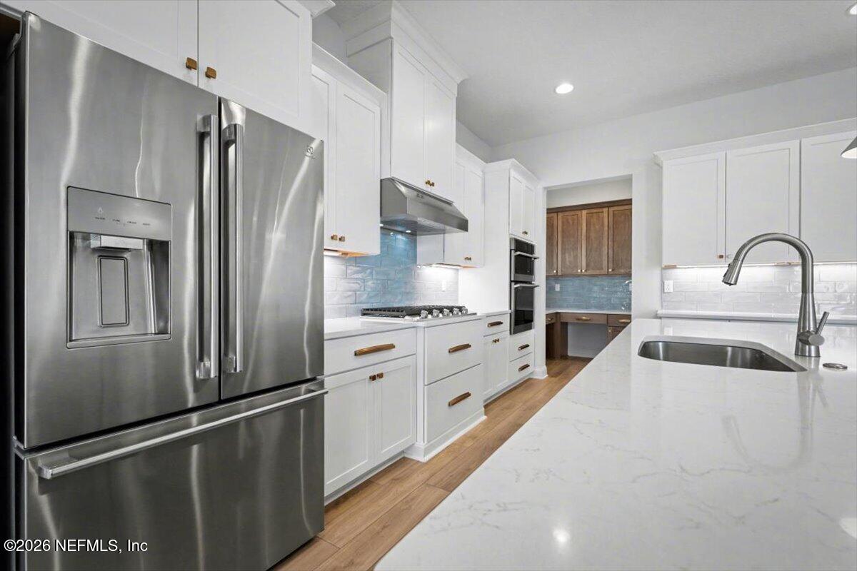 113 Grand Rivage Drive St. Augustine, FL 32092 - Photo 13 of 22 a kitchen with granite countertop a refrigerator and a sink