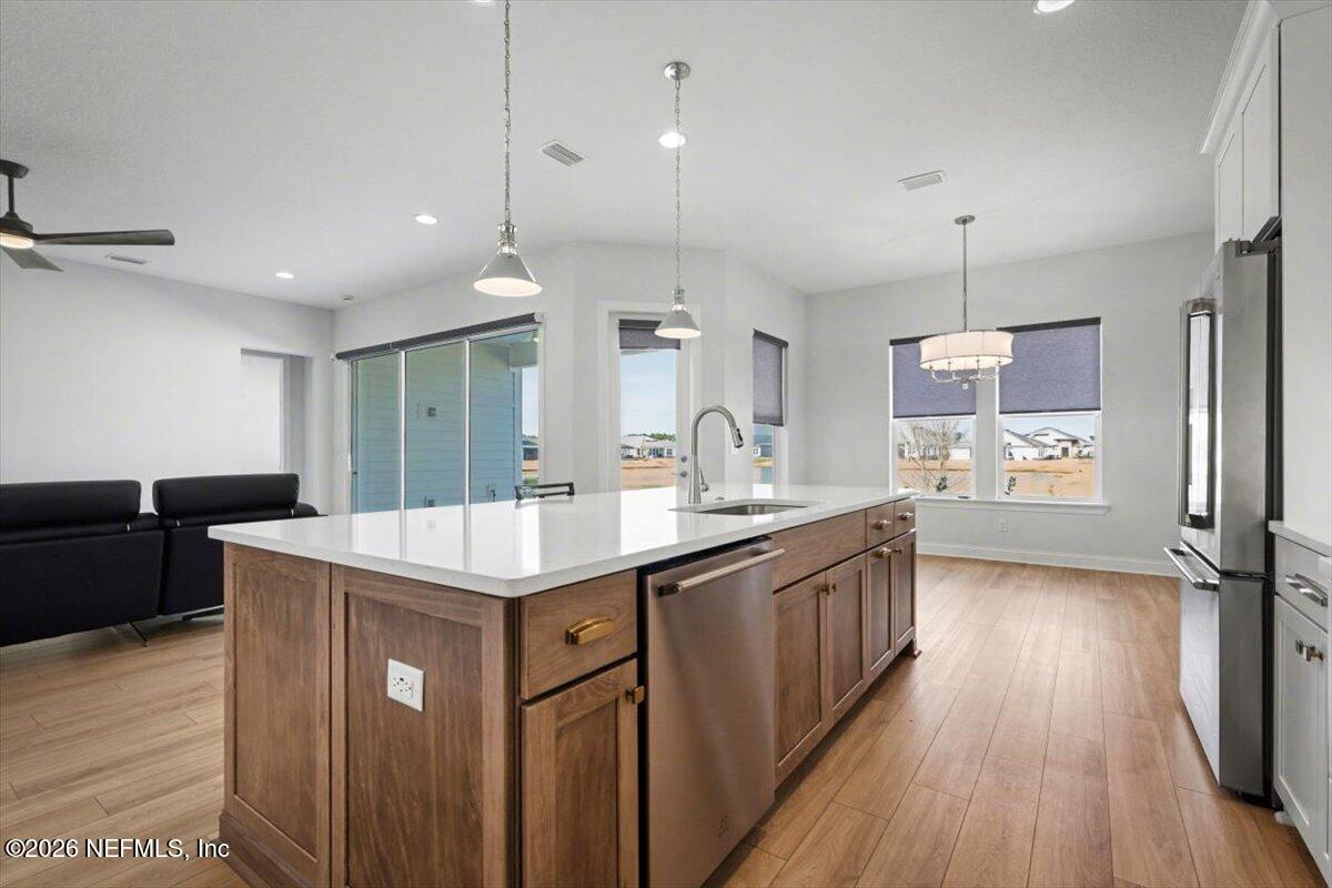 113 Grand Rivage Drive St. Augustine, FL 32092 - Photo 15 of 24 a kitchen with stainless steel appliances granite countertop a sink stove and wooden floor