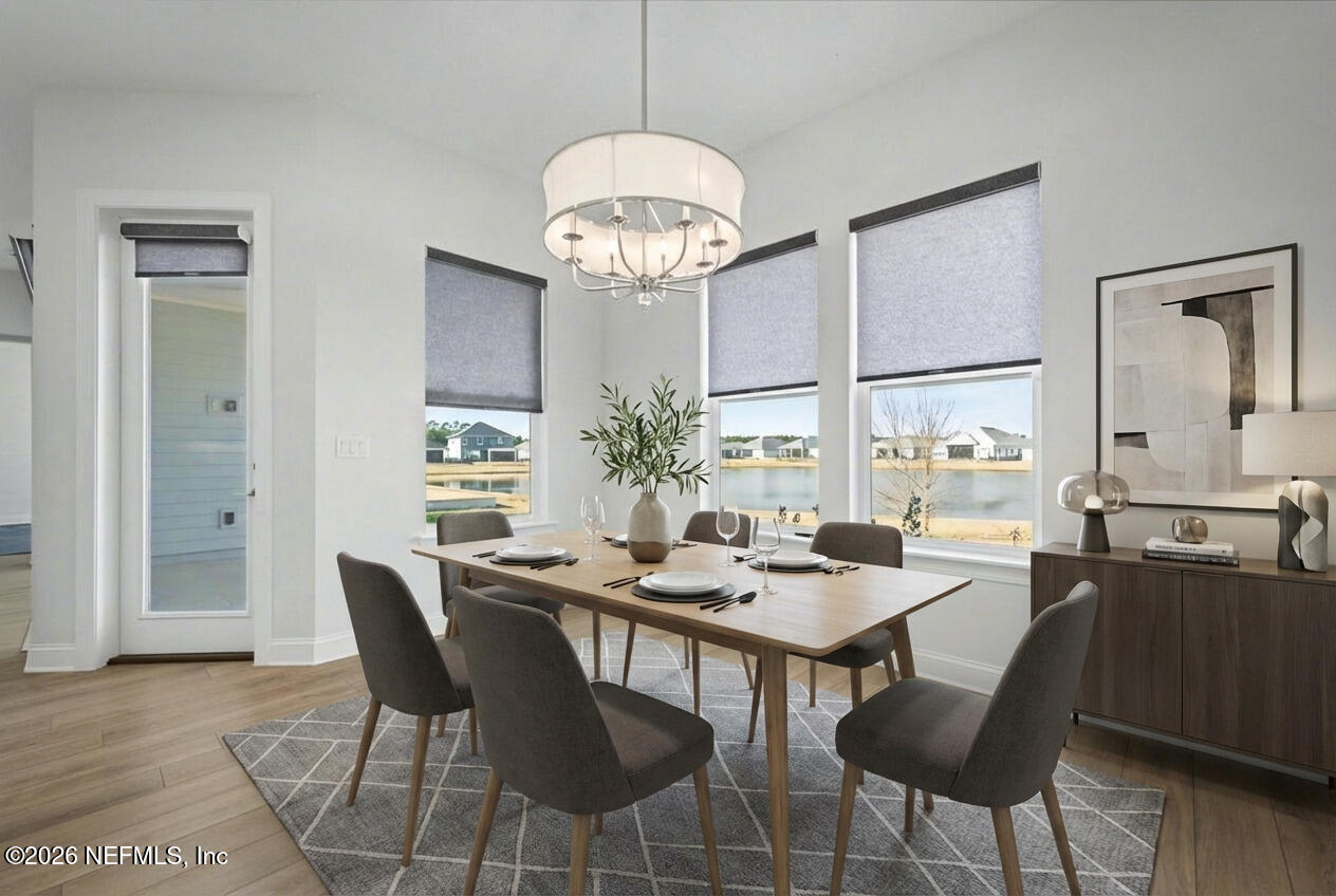 113 Grand Rivage Drive St. Augustine, FL 32092 - Photo 17 of 22 a dining room with wooden floor a chandelier a wooden table and chairs