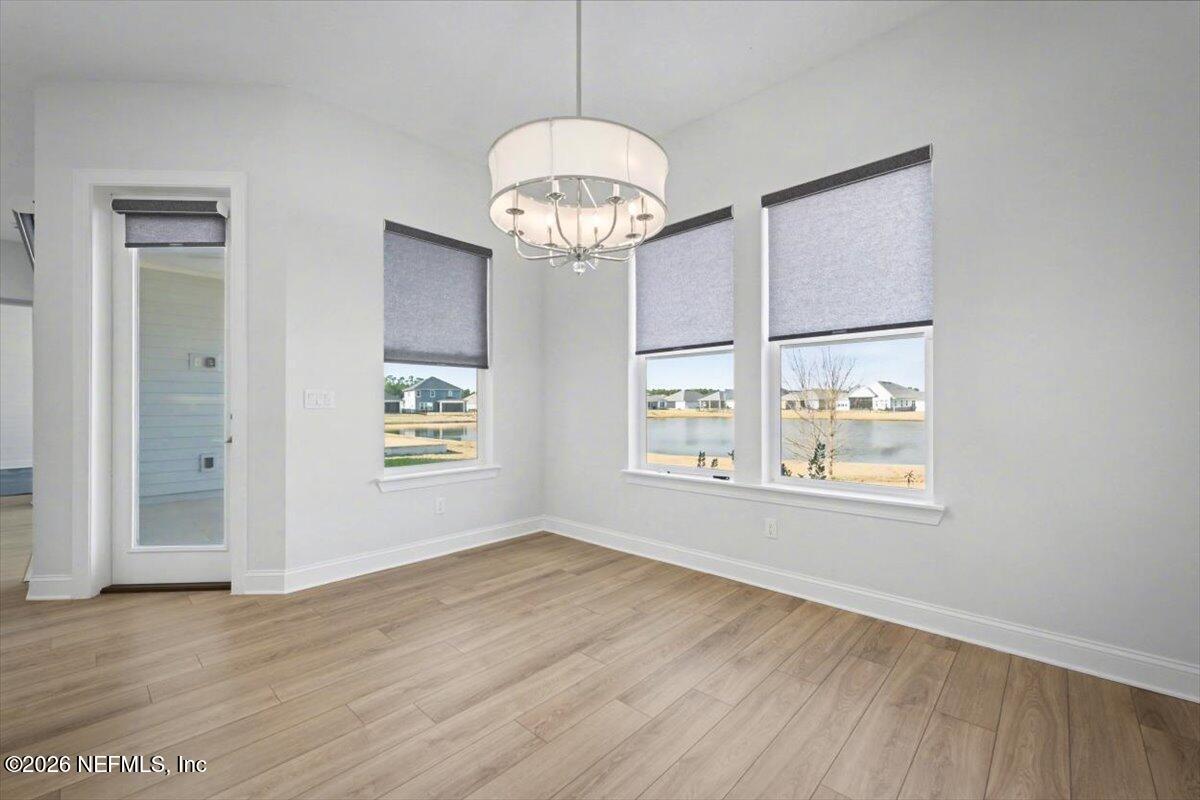 113 Grand Rivage Drive St. Augustine, FL 32092 - Photo 18 of 24 an empty room with wooden floor and windows