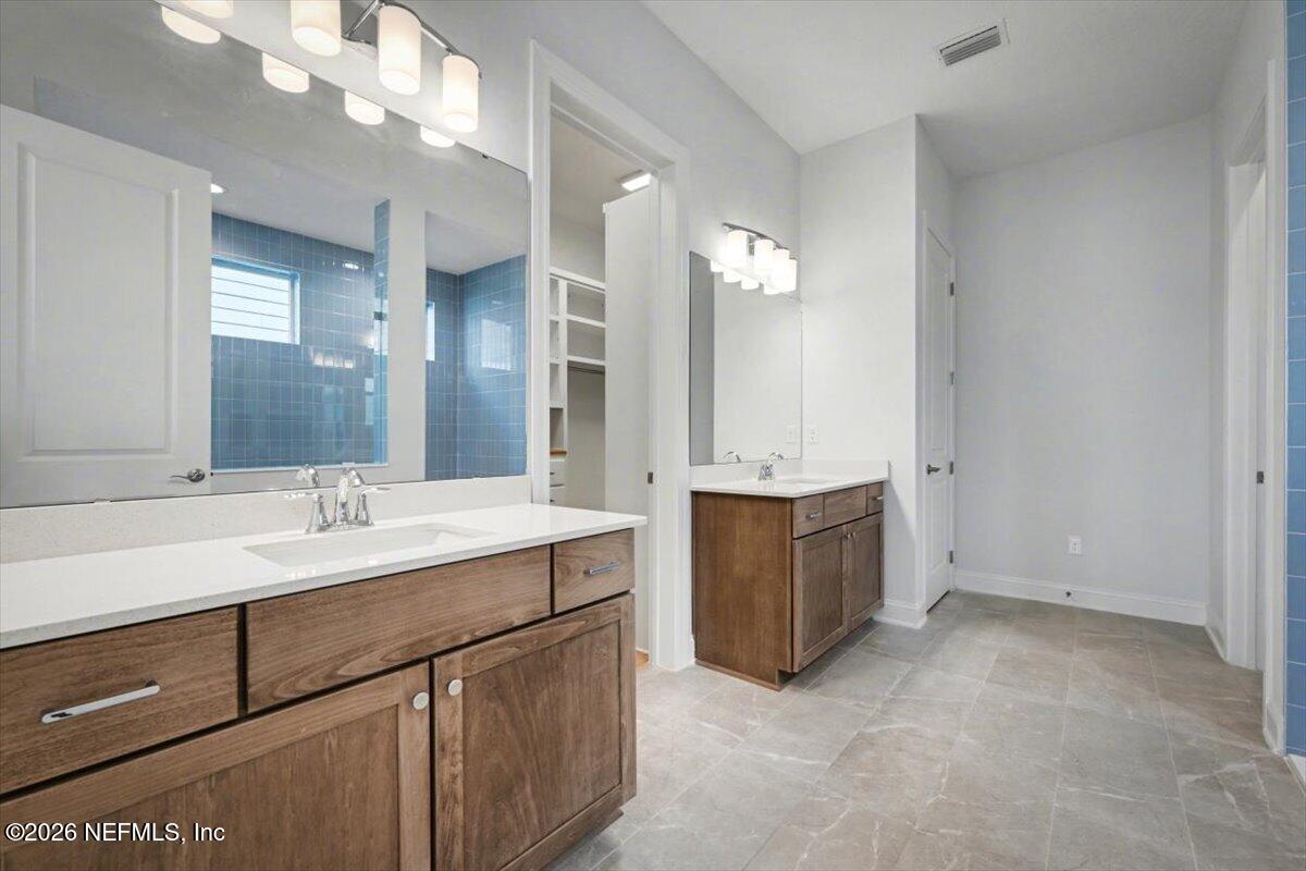 113 Grand Rivage Drive St. Augustine, FL 32092 - Photo 19 of 22 a bathroom with a sink vanity and mirror
