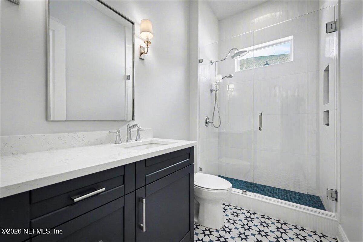 113 Grand Rivage Drive St. Augustine, FL 32092 - Photo 6 of 24 a bathroom with a sink a toilet a shower and a mirror