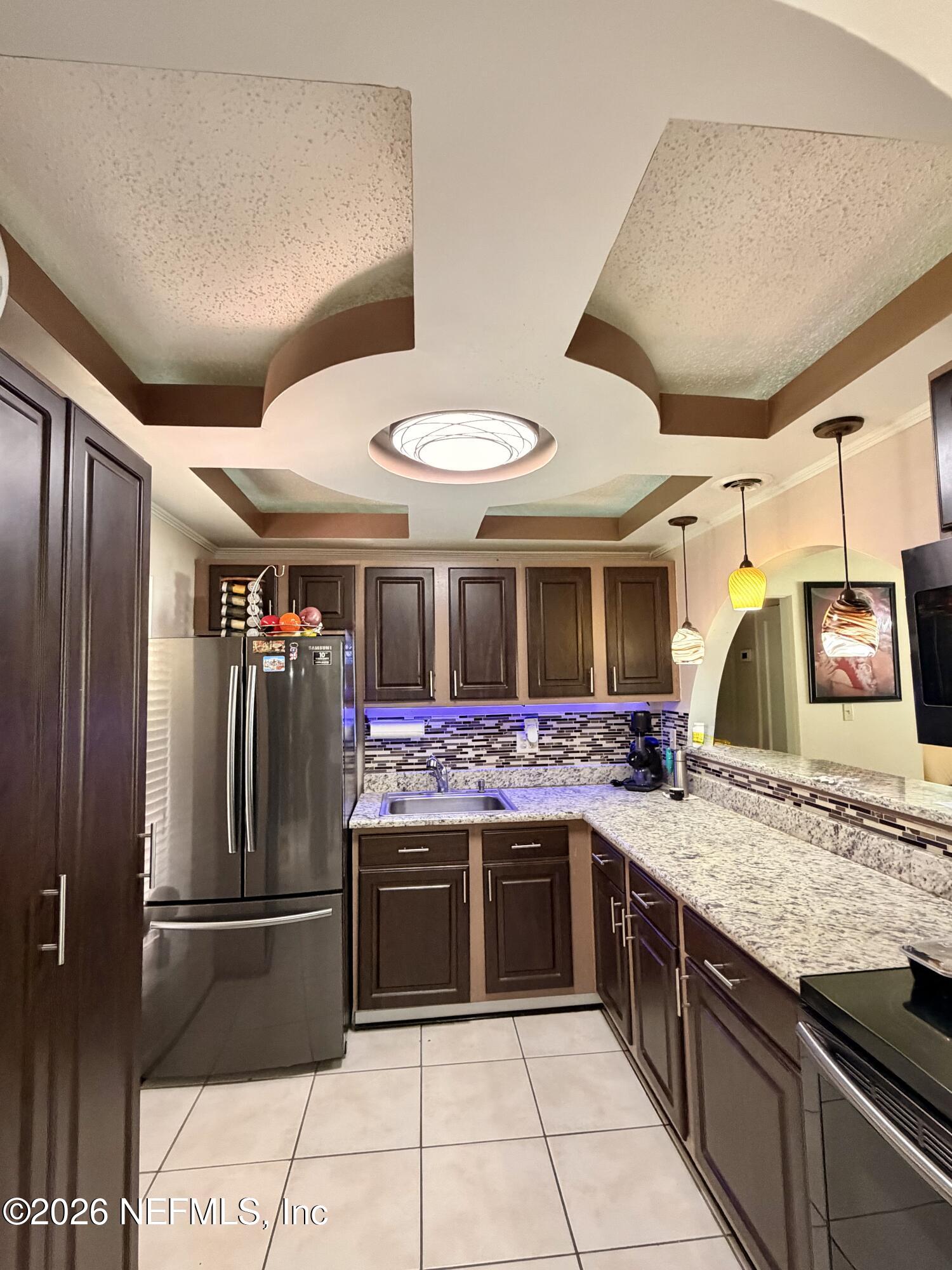 4127 Springwood Road Jacksonville, FL 32207 - Photo 11 of 63 a kitchen with stainless steel appliances granite countertop a sink and a refrigerator