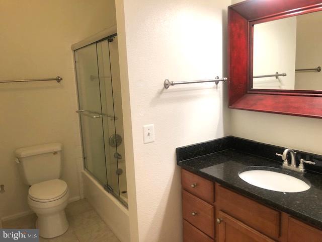 1601 Spring Gate Dr., Unit 1214 McLean, VA 22102 - Photo 13 of 17 a bathroom with a granite countertop sink toilet and a mirror