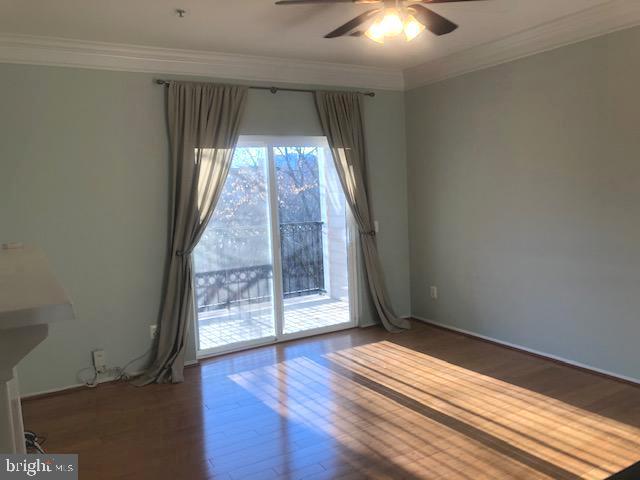 1601 Spring Gate Dr., Unit 1214 McLean, VA 22102 - Photo 5 of 17 an empty room with wooden floor fan and windows
