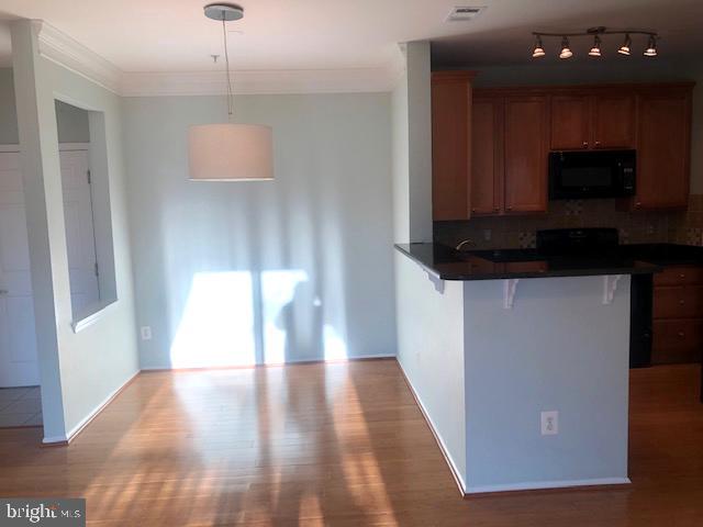 1601 Spring Gate Dr., Unit 1214 McLean, VA 22102 - Photo 6 of 17 a view of a kitchen with a sink and a microwave