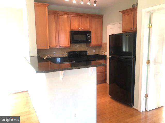 1601 Spring Gate Dr., Unit 1214 McLean, VA 22102 - Photo 9 of 17 a kitchen with a refrigerator and a microwave