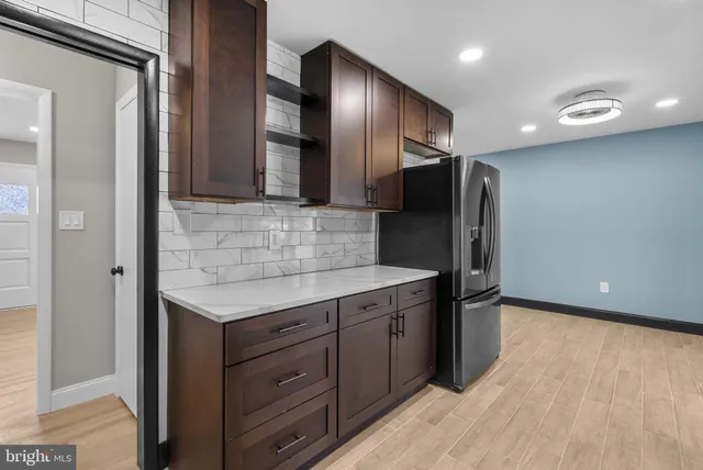 a kitchen with stainless steel appliances granite countertop a refrigerator and a sink