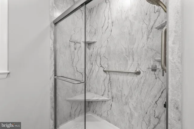 a bathroom with a glass shower door