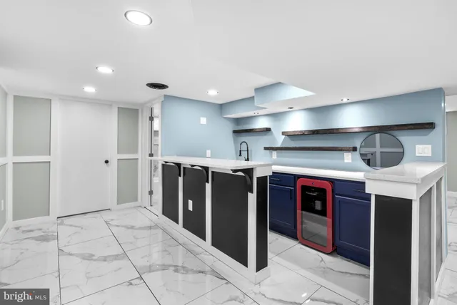 a open kitchen with stainless steel appliances granite countertop a refrigerator and a sink