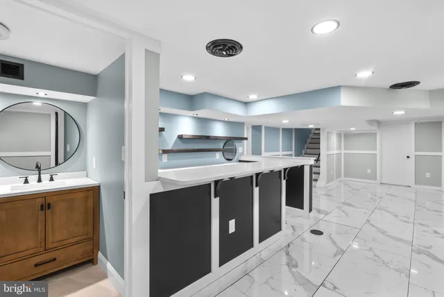 a kitchen with stainless steel appliances a sink stove and cabinets