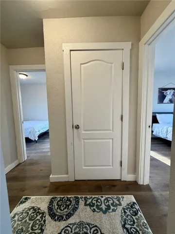a view of bedroom with a bed and wooden floor