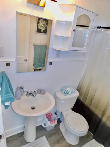 a white toilet sitting next to a bathroom sink