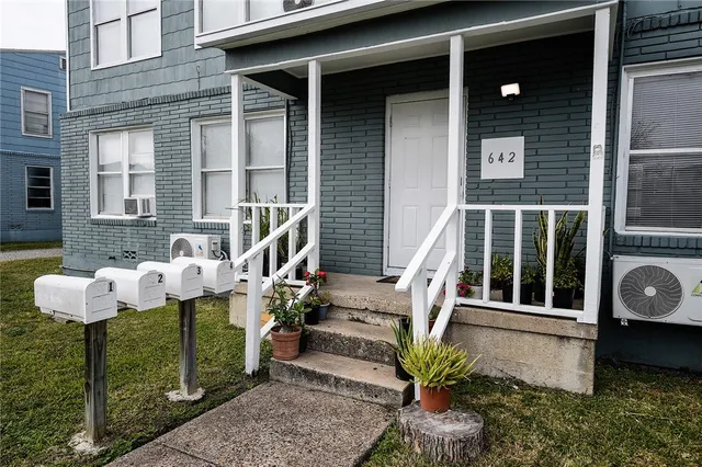 a front view of a house with outdoor seating and stairs