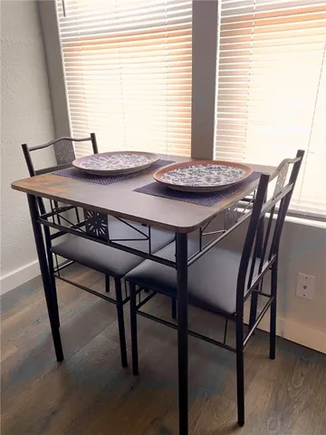 a view of a dining room with furniture and window