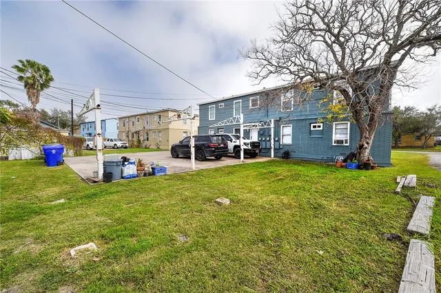 a view of a house with a big yard and large trees