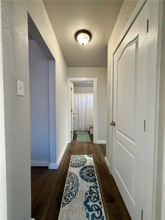 a view of bedroom with wooden floor