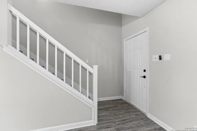 a view of an entryway with wooden floor
