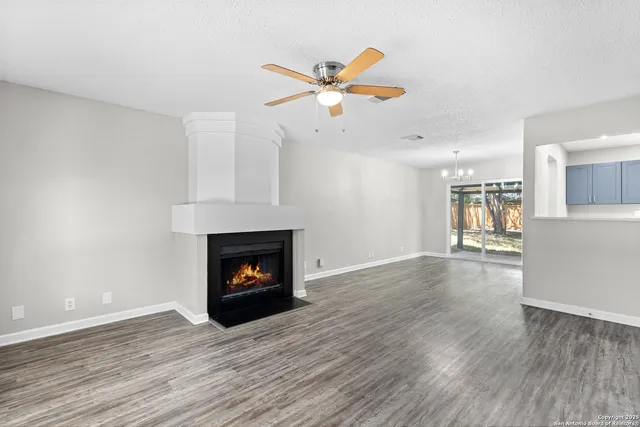 a living room with wooden floors and a fireplace