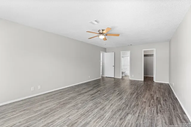 a view of a livingroom with a hardwood floor and a ceiling fan
